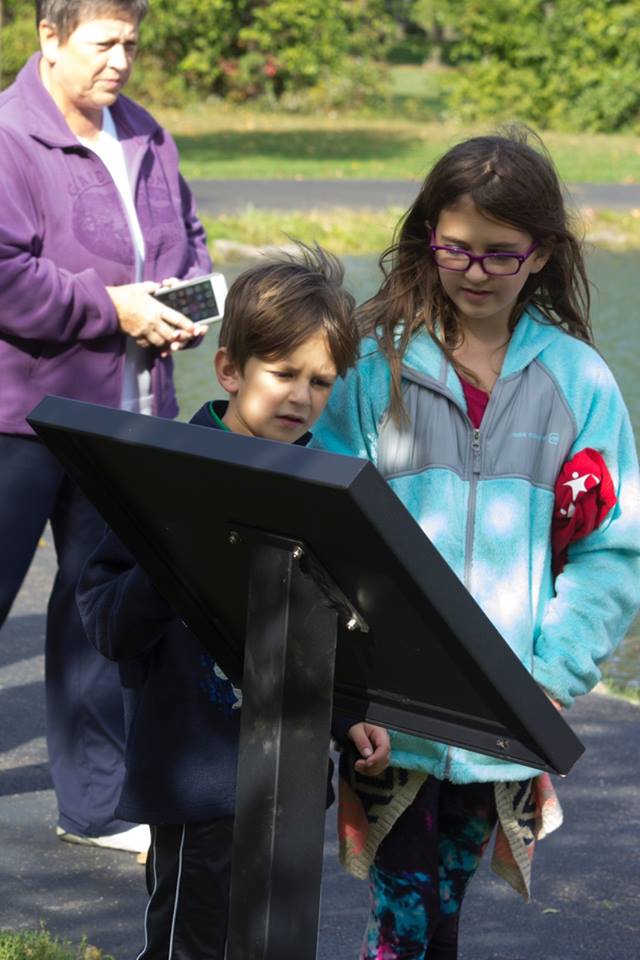 family reading storywalk(r) at dover city park