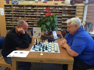 two patrons playing chess in the library