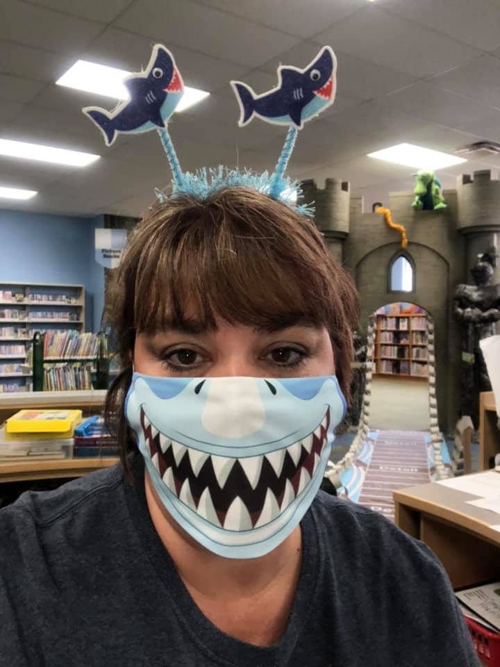 Ms. Jen wearing a shark headband and a shark mask